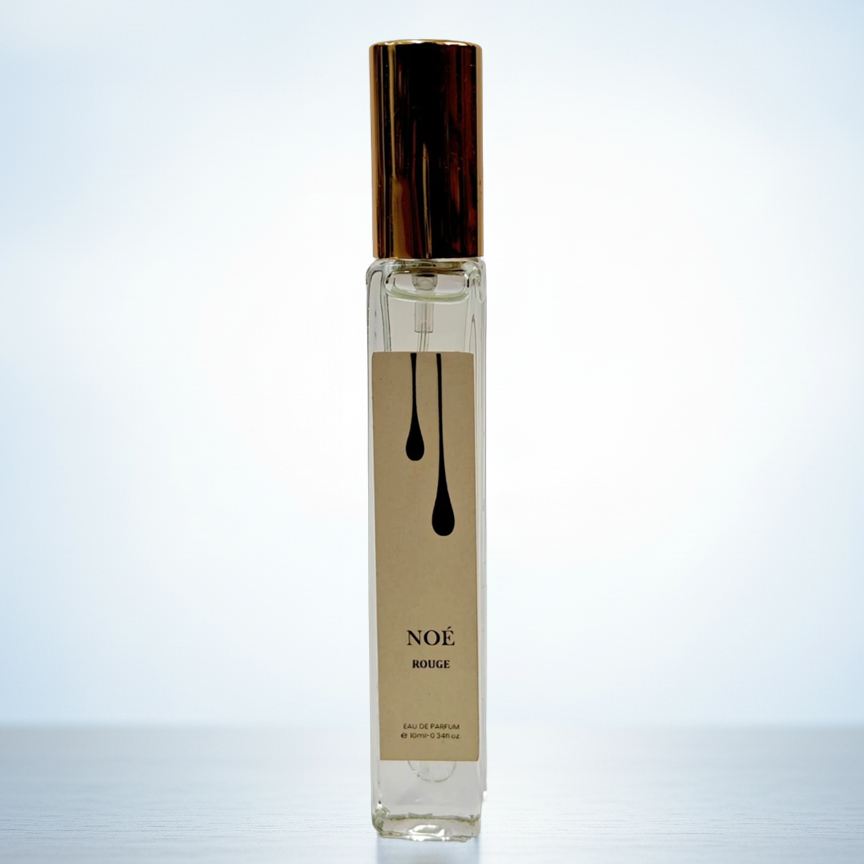 Perfume bottle labeled 'NOE' on a light blue background