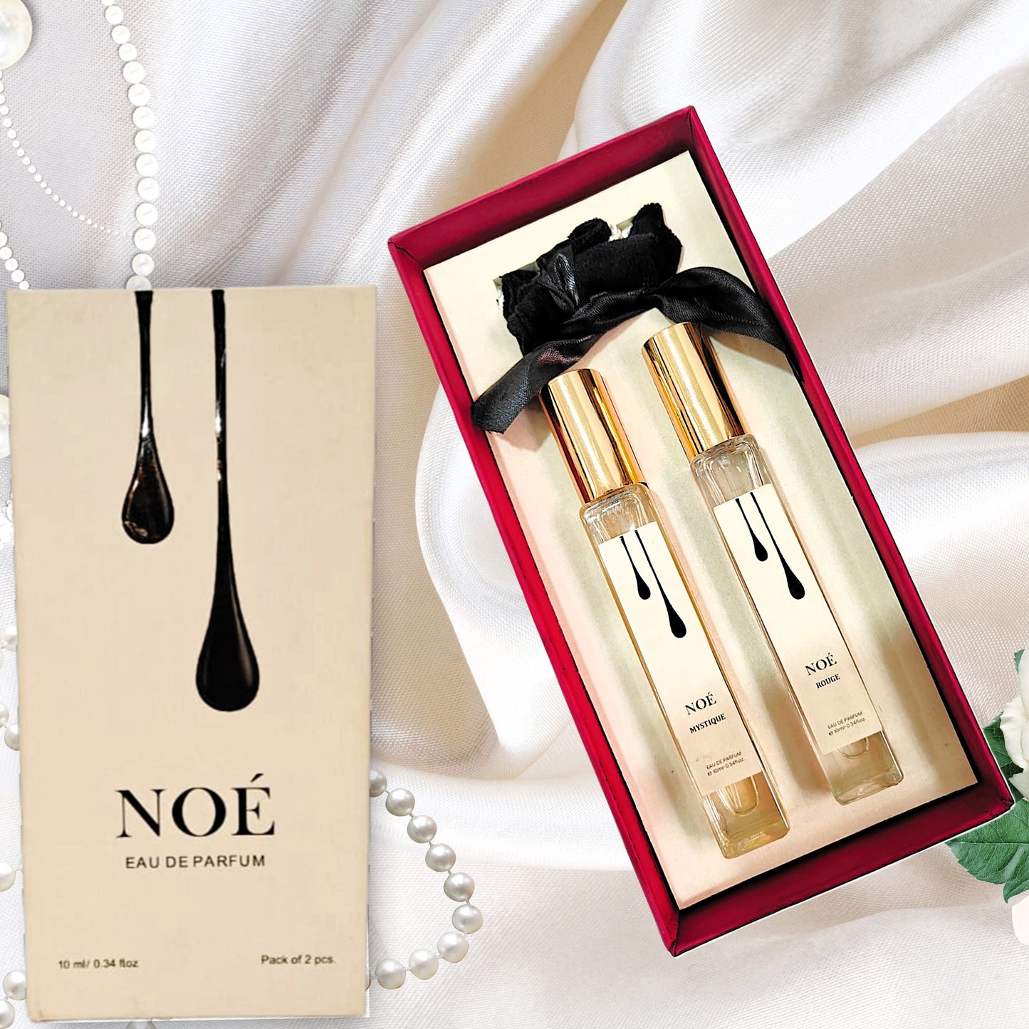 NOÉ Eau de Parfum gift set with two 10ml perfume bottles in a red box on white fabric background