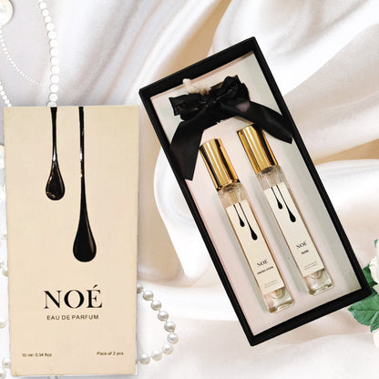 NOÉ Eau de Parfum gift set with two 10ml spray bottles on white satin background